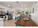 Open kitchen featuring white cabinets, stainless steel appliances, and a view into the living room at 2135 Pocahontas Dr, Largo, FL 33774