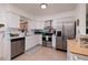 Modern kitchen with white cabinets, stainless steel appliances, and ample counter space at 2135 Pocahontas Dr, Largo, FL 33774