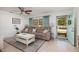 Comfortable living room with a large sofa, a ceiling fan, and bright curtains at 2135 Pocahontas Dr, Largo, FL 33774