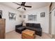 Inviting living room with a comfortable gray sectional sofa, bright windows, and neutral-toned carpeting at 2135 Pocahontas Dr, Largo, FL 33774