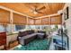 Bright sunroom with multiple windows, a comfortable seating area, and a ceiling fan at 2135 Pocahontas Dr, Largo, FL 33774