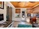 Cozy sunroom with wood ceiling, tiled floor, natural light, and a door leading to the backyard at 2135 Pocahontas Dr, Largo, FL 33774