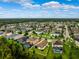 Bird's eye view of neighborhood with private pools, lawns and mature trees at 21395 Southern Charm Dr, Land O Lakes, FL 34637