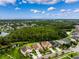 Neighborhood aerial view highlighting backyard landscape, houses, trees, and a lake at 21395 Southern Charm Dr, Land O Lakes, FL 34637