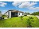 Large backyard featuring a screened patio and fresh landscaping, great for outdoor living at 21395 Southern Charm Dr, Land O Lakes, FL 34637