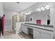 Bright primary bathroom features a double sink vanity, a framed shower, and neutral walls at 21395 Southern Charm Dr, Land O Lakes, FL 34637