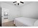 Bedroom boasts neutral walls, carpet, a ceiling fan, and an ensuite bathroom at 21395 Southern Charm Dr, Land O Lakes, FL 34637