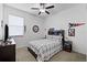 Cozy bedroom with ceiling fan, natural light, carpeted floor, and baseball decor at 21395 Southern Charm Dr, Land O Lakes, FL 34637