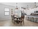 Open concept floorplan features the dining area adjacent to the kitchen with stainless steel appliances at 21395 Southern Charm Dr, Land O Lakes, FL 34637