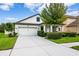 Inviting two-story home with a two-car garage, manicured landscaping, and a well-maintained lawn at 21395 Southern Charm Dr, Land O Lakes, FL 34637