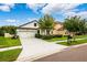 Charming two-story home with manicured lawn, a two-car garage, and well-maintained landscaping at 21395 Southern Charm Dr, Land O Lakes, FL 34637
