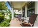 Inviting front porch with rocking chairs and a view of the lush, landscaped yard at 21395 Southern Charm Dr, Land O Lakes, FL 34637