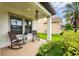 Inviting covered front porch featuring seating for relaxing and enjoying the outdoors at 21395 Southern Charm Dr, Land O Lakes, FL 34637