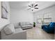 Cozy living room featuring tile flooring, ample natural light, and comfortable seating at 21395 Southern Charm Dr, Land O Lakes, FL 34637