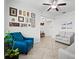 Bright living room featuring tile flooring, comfortable seating, and decorative artwork at 21395 Southern Charm Dr, Land O Lakes, FL 34637