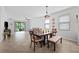 Open living room with lots of natural light leading to a screened in lanai at 21395 Southern Charm Dr, Land O Lakes, FL 34637
