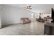 A spacious living area features a living room with a kitchen and dining area in the background at 21395 Southern Charm Dr, Land O Lakes, FL 34637