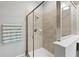 The framed shower features neutral tile and a glass enclosure at 21395 Southern Charm Dr, Land O Lakes, FL 34637