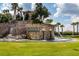 Landscaped entrance of The Ridge at Wiregrass Ranch featuring a stone waterfall at 2388 Oakwood Preserve Dr, Wesley Chapel, FL 33543
