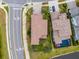 Aerial view of the property with its fenced backyard, close proximity to the community pool, and tile roof at 2388 Oakwood Preserve Dr, Wesley Chapel, FL 33543