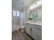 Neutral bathroom features a single vanity with framed mirror, tub and shower at 2388 Oakwood Preserve Dr, Wesley Chapel, FL 33543
