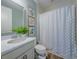 Bathroom with modern vanity, framed art, and a patterned shower curtain at 2388 Oakwood Preserve Dr, Wesley Chapel, FL 33543