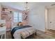 Stylish bedroom features a unique chandelier, accent wall, floating shelves and lots of natural light at 2388 Oakwood Preserve Dr, Wesley Chapel, FL 33543