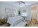 Bedroom features light walls, wood floors, a mirror, vanity and a comfortable bed with decorative pillows at 2388 Oakwood Preserve Dr, Wesley Chapel, FL 33543