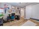 Well-lit bedroom boasts baseball memorabilia, a black desk, light wood floors, and a closet with sliding doors at 2388 Oakwood Preserve Dr, Wesley Chapel, FL 33543