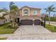 Beautiful two-story home featuring a paver driveway, an attached two-car garage, and lovely landscaping at 2388 Oakwood Preserve Dr, Wesley Chapel, FL 33543