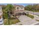 Stunning two-story home featuring a paver driveway, mature palms, and a two-car garage at 2388 Oakwood Preserve Dr, Wesley Chapel, FL 33543