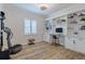 Home office featuring built-in shelves, a desk area, and exercise equipment at 2388 Oakwood Preserve Dr, Wesley Chapel, FL 33543