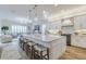 Spacious kitchen with a large island, marble countertops, and sleek white cabinetry at 2388 Oakwood Preserve Dr, Wesley Chapel, FL 33543