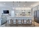 Modern kitchen featuring a large island with marble countertops, pendant lights, and stainless steel appliances at 2388 Oakwood Preserve Dr, Wesley Chapel, FL 33543