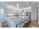 Bright kitchen featuring large island with marble countertops and stainless steel appliances at 2388 Oakwood Preserve Dr, Wesley Chapel, FL 33543