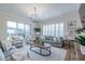 Bright living room with a view of the backyard, shuttered windows and chandelier at 2388 Oakwood Preserve Dr, Wesley Chapel, FL 33543