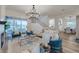 Open-concept living room with a fireplace, stylish seating, and a view of the lake at 2388 Oakwood Preserve Dr, Wesley Chapel, FL 33543