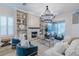 Open-concept living room with a fireplace, built-in shelves, and access to the outdoor living area at 2388 Oakwood Preserve Dr, Wesley Chapel, FL 33543