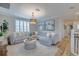 Comfortable living room area with a large sectional, shutters, decor and a decorative coffee table at 2388 Oakwood Preserve Dr, Wesley Chapel, FL 33543