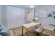 Office space includes a white desk, a sliding door closet and light blue walls at 2388 Oakwood Preserve Dr, Wesley Chapel, FL 33543