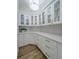 Organized pantry with white cabinets, glass doors, and ample storage space at 2388 Oakwood Preserve Dr, Wesley Chapel, FL 33543