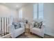 Upstairs sitting area featuring two chairs with throw pillows and shutters on the window at 2388 Oakwood Preserve Dr, Wesley Chapel, FL 33543