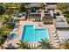 Aerial view of a community pool, hot tub, and surrounding buildings with palm trees at 2400 Winding Creek Blvd # 4-101, Clearwater, FL 33761