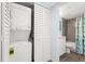 Bathroom featuring a tiled shower/bath, toilet, and stackable washer and dryer at 2400 Winding Creek Blvd # 4-101, Clearwater, FL 33761