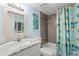 Bathroom featuring a shower/tub combo with colorful mermaid themed shower curtain at 2400 Winding Creek Blvd # 4-101, Clearwater, FL 33761