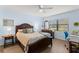 Relaxing bedroom featuring wood floors, a window view, and a ceiling fan at 2400 Winding Creek Blvd # 4-101, Clearwater, FL 33761