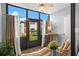 Screened patio with tile floor, hanging plants, and view of exterior green space at 2400 Winding Creek Blvd # 4-101, Clearwater, FL 33761