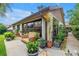 Inviting back patio with cushioned seating, potted plants, and a view of the serene garden at 2475 Bay Berry Dr, Clearwater, FL 33763
