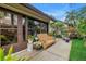 Relaxing outdoor patio with comfortable seating, potted plants, and views of the lush backyard at 2475 Bay Berry Dr, Clearwater, FL 33763
