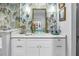 Bathroom featuring a glass bowl sink, wallpaper, and gold fixtures at 2475 Bay Berry Dr, Clearwater, FL 33763